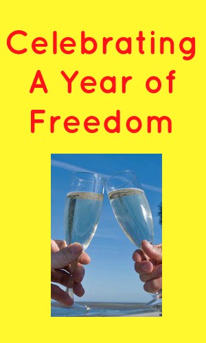 Celebrating a year of freedom in red text on a yellow background with a picc of two champagne glasses being clinked together