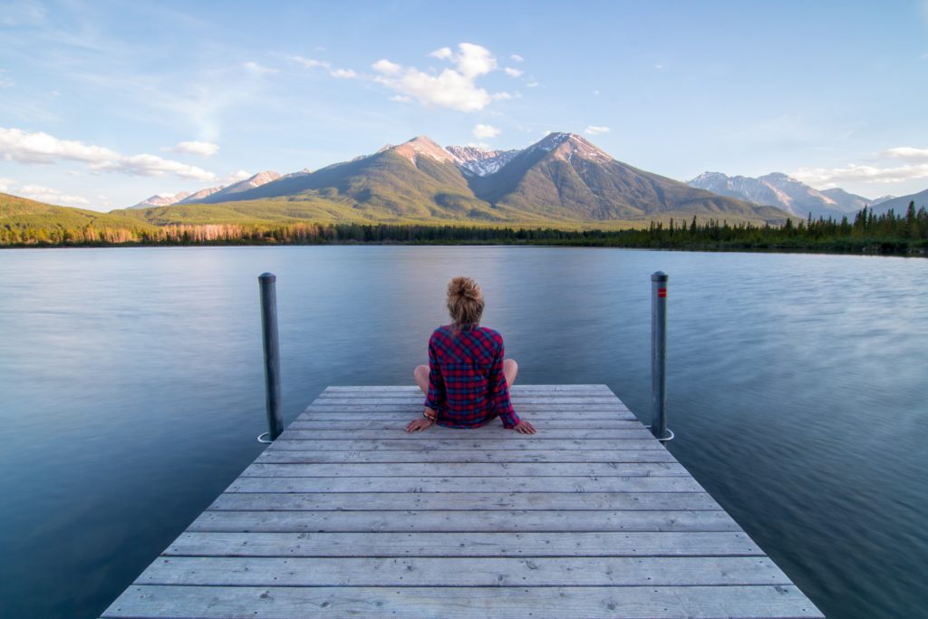 girl sitting on a pier