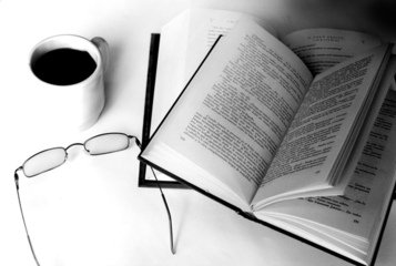 Open book with glasses and coffee