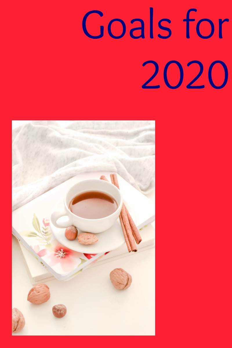 Goals for 2020 in blue text on a dark pink background above a photo of a cup of coffee