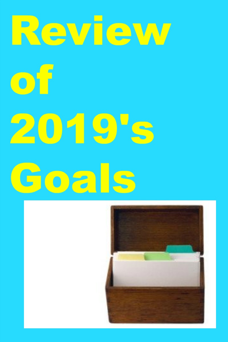 Review of 2019's Goals in yellow text on a turquoise background above a photo of a index card holder