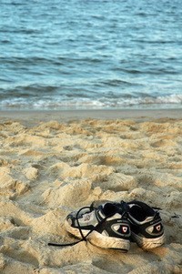 Beach scene with shoes on the sand