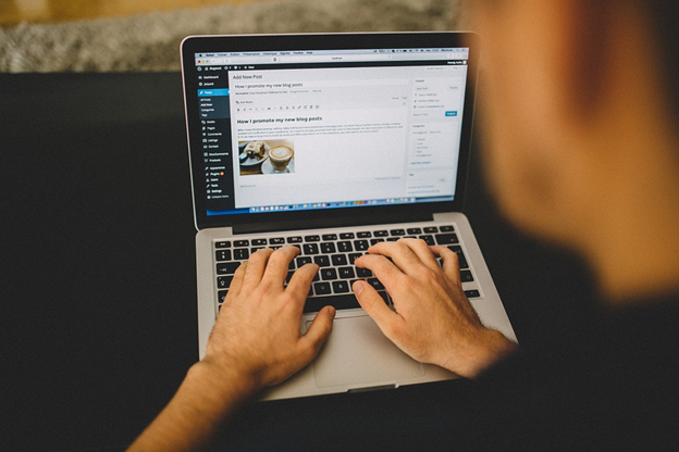 hands typing on a laptop